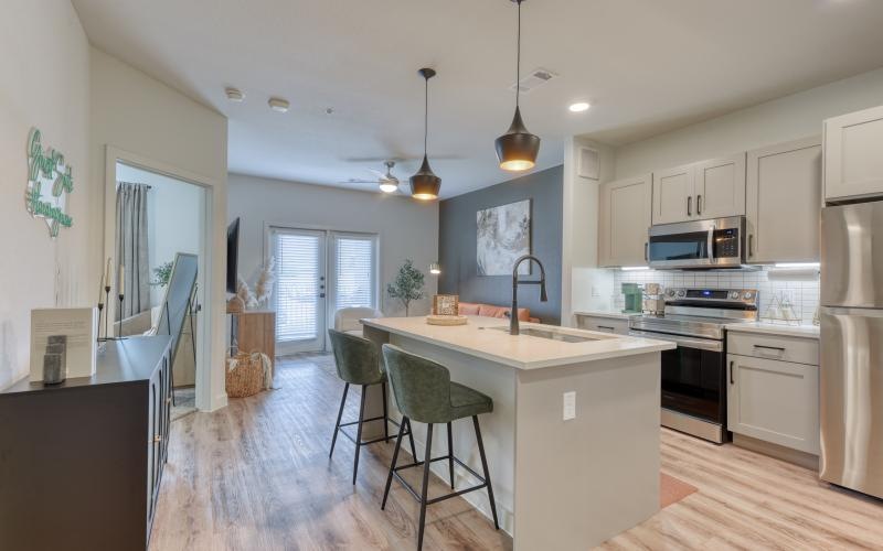 a kitchen with a bar stool and a table