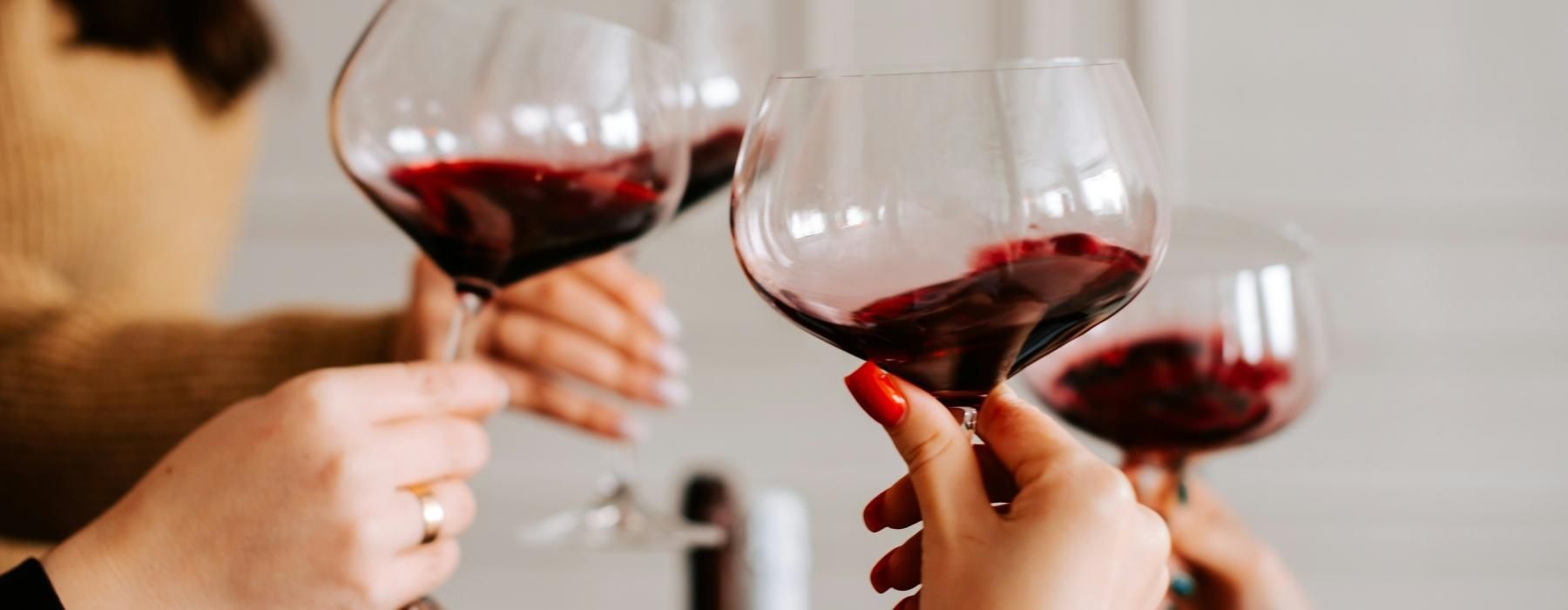 a few people holding wine glasses